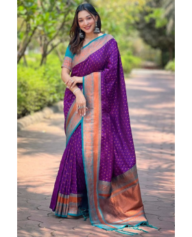 The 1000 butti concept tilak zari is featured in this purple Paithani saree.